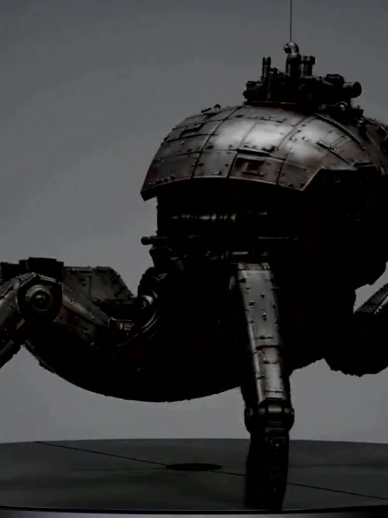 A six-legged armoured walker machine, unarmed, on a neutral stage